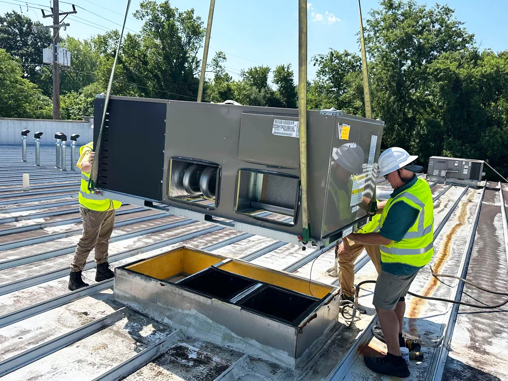 Puffin Mechanical technicians on the roof replacing an Commercial HVAC system for a local Hampton Roads, VA business