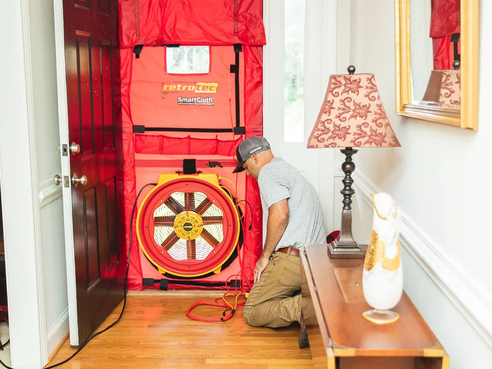 Puffin Mechanical Technician setting up the blower door test during the Home Performance Test