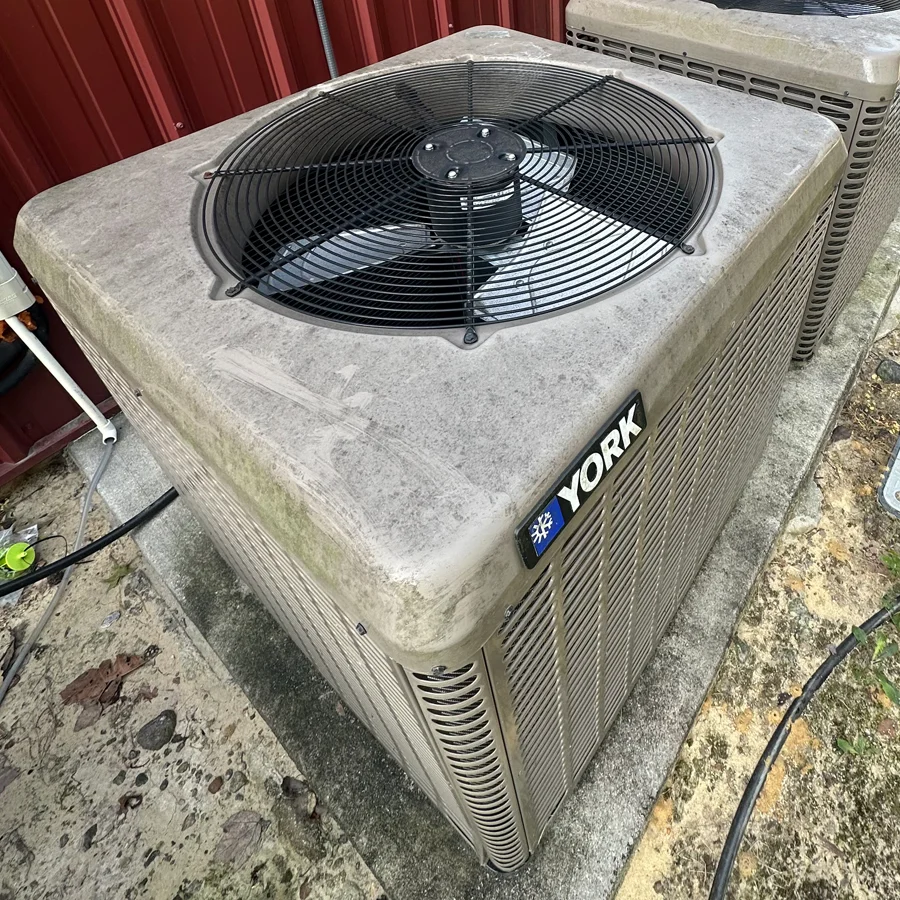 A dirty HVAC outdoor condenser coil